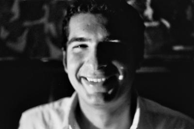 A black and white headshot of Alex Cabal.